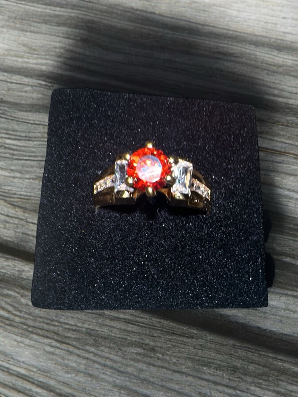 Gold-Tone Ring with Orange Center Stone and Clear Side Stones